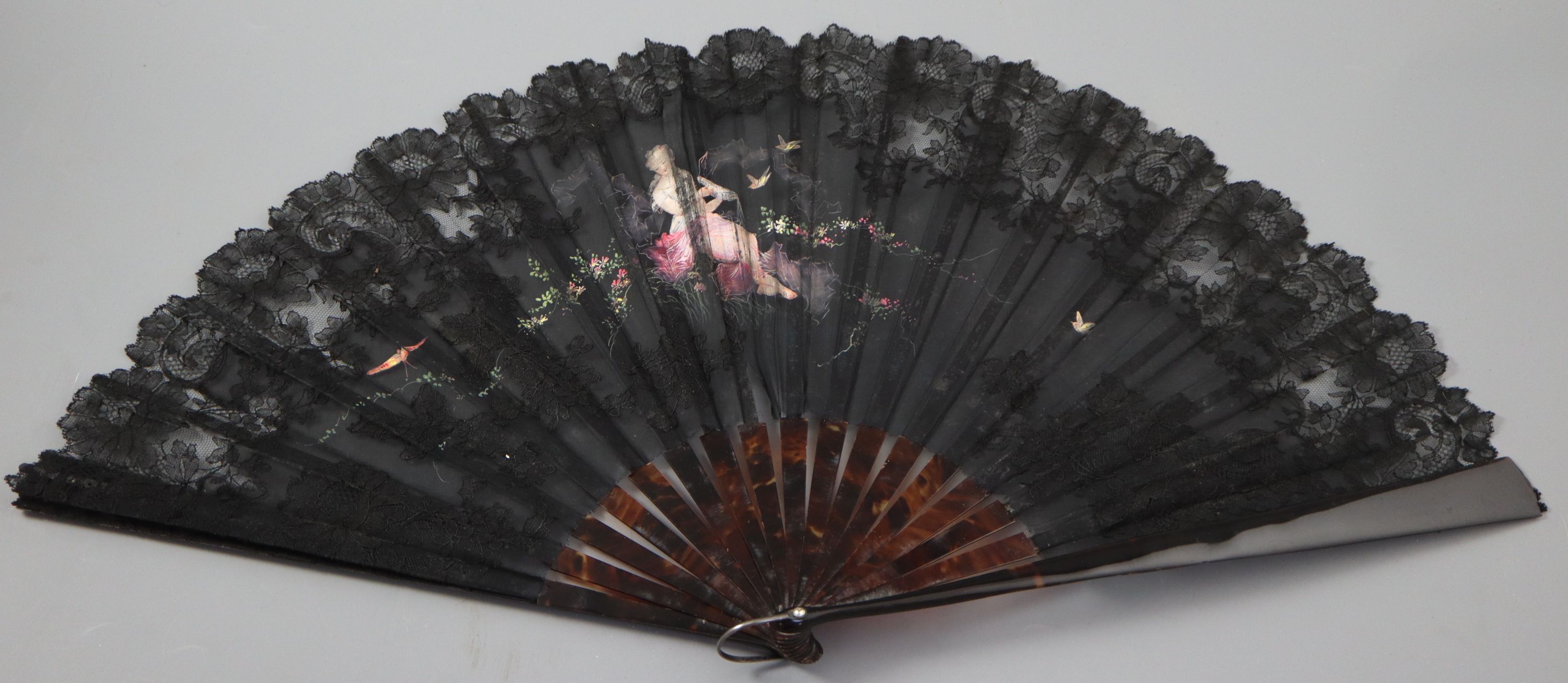 An early 19th century English bone, ivory and chicken skin fan and an Oskar Zeibig fan